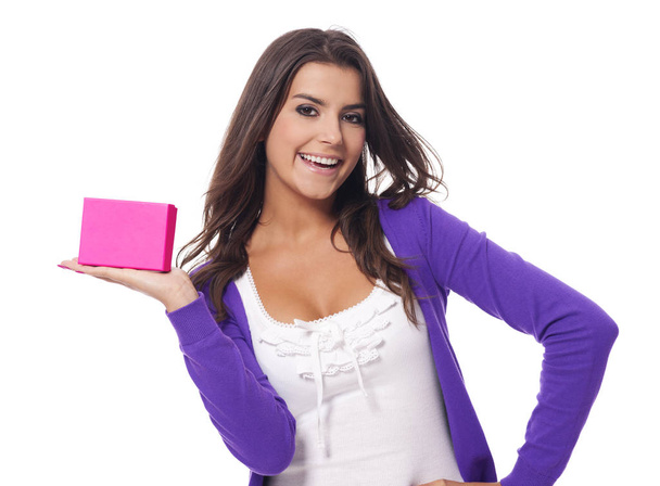Cute young woman holding pink present   - Φωτογραφία, εικόνα