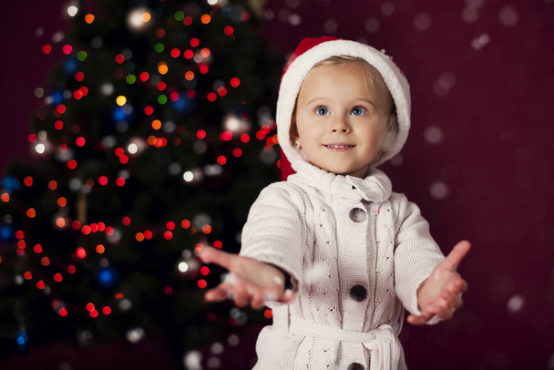 Santa little girl playing in snowflakes - Fotoğraf, Görsel