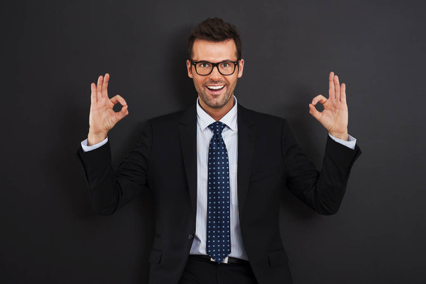 Happy businessman wearing glasses showing OK sign  - Valokuva, kuva