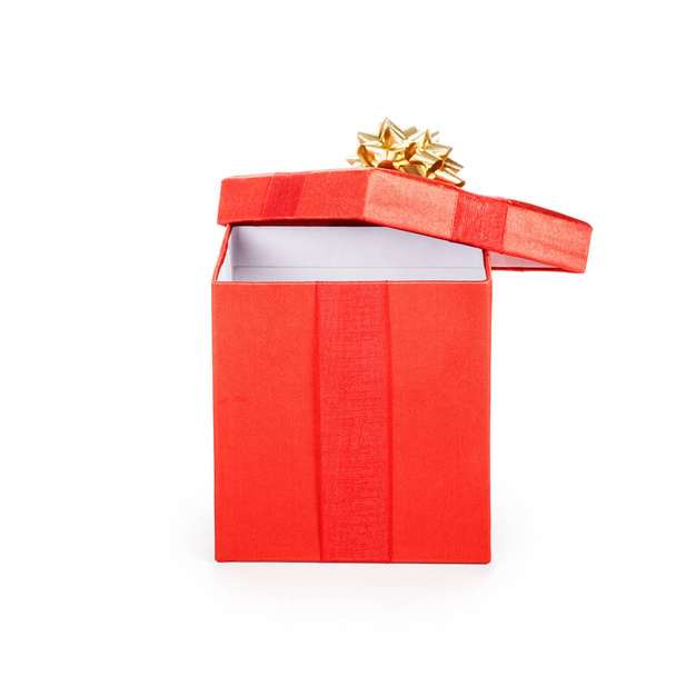 Open red gift box with gold ribbon. Christmas theme. Object isolated on white background. Clipping path. - Фото, изображение