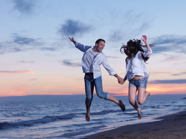 happy young romantic couple in love have fun on beautiful beach at beautiful summer day - Photo, Image