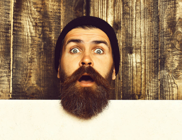 Bearded brutal caucasian hipster with white paper sheet - Фото, изображение