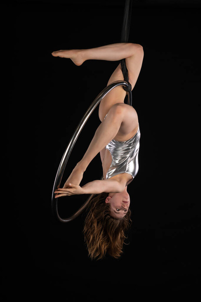 Brunette acrobat on a lyra - 写真・画像