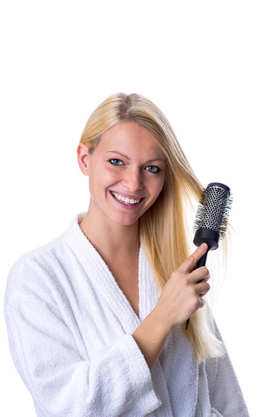 blonde with hairbrush in hand - Фото, изображение