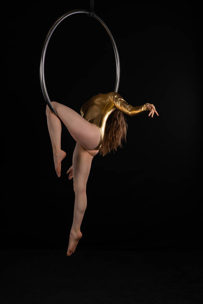 Brunette acrobat on a lyra - Фото, зображення