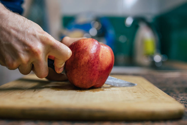 Close Up Of Man's Hands Cutting Apple - Фото, изображение