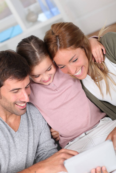Family using electronic tablet at home - Fotó, kép