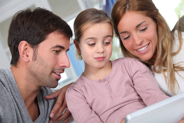 Family using electronic tablet at home - Φωτογραφία, εικόνα