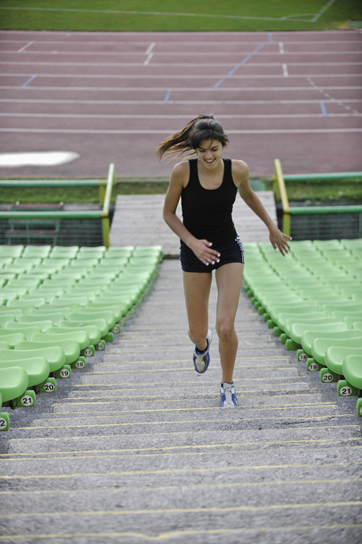 Woman jogging at athletics stadium - Фото, изображение