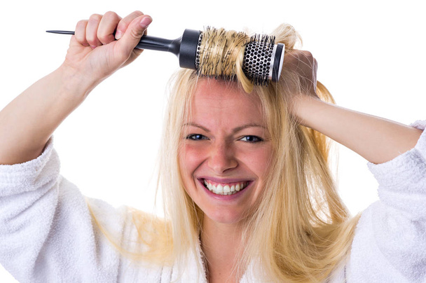 blonde with hairbrush in her hand - 写真・画像