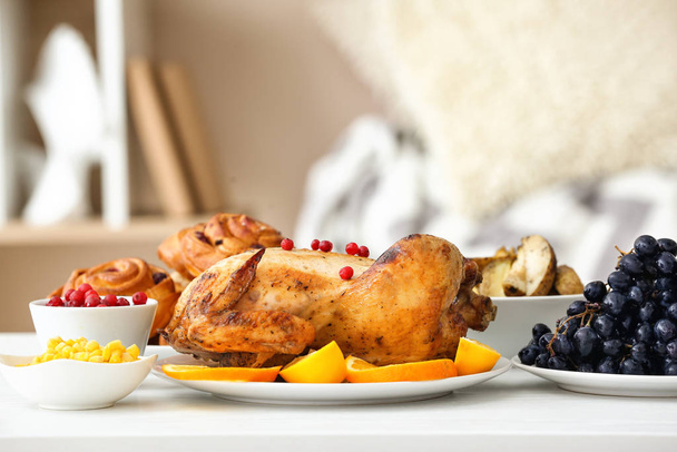 Tasty baked turkey and different food for Thanksgiving day on table - Fotografie, Obrázek