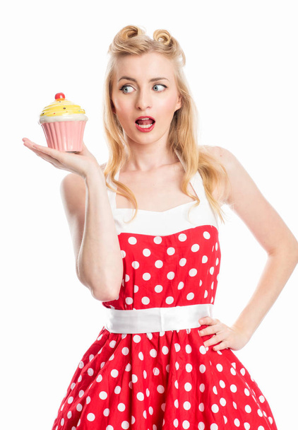 a woman in summer dress holds a delicious cupcake in her hand - Zdjęcie, obraz