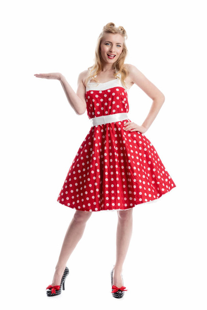 young woman in rockabilly dress shows with hand - Valokuva, kuva