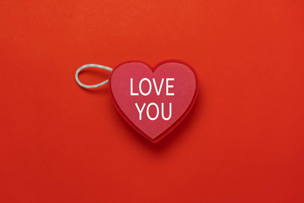 Table top view image of decoration valentine's day holiday background concept.Flat lay essential object sign of heart shape with love you word for season on red paper at office desk studio. - Photo, Image