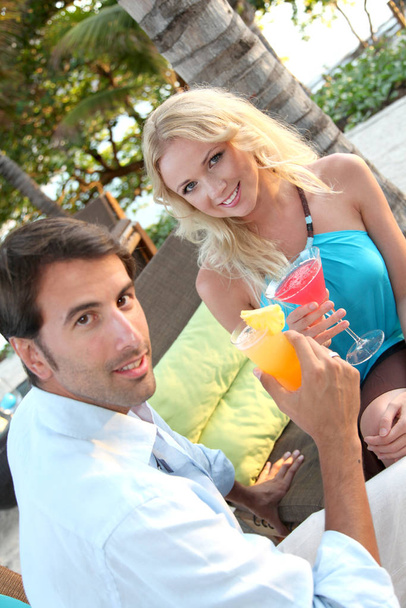 Just married couple having a cocktail in luxury resort - Fotó, kép