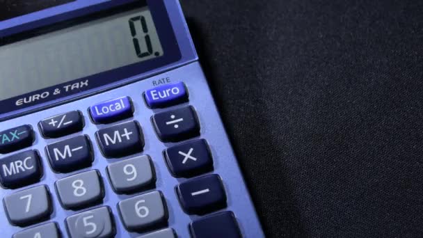 Mano masculina calculando con una calculadora doméstica diferentes operaciones
 - Metraje, vídeo