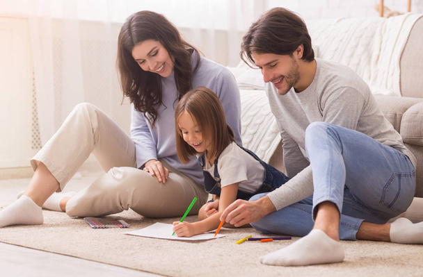 Cute Little Girl Drawing On Floor With Her Parents, Bonding Together - Photo, Image