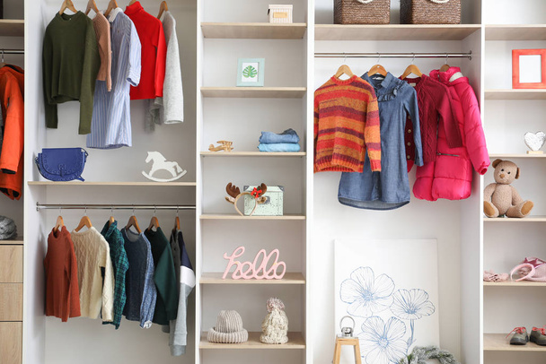 Modern wardrobe with stylish winter clothes and accessories - Fotoğraf, Görsel