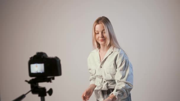 young girl recording video about makeup with photo camera attached to tripod - Footage, Video