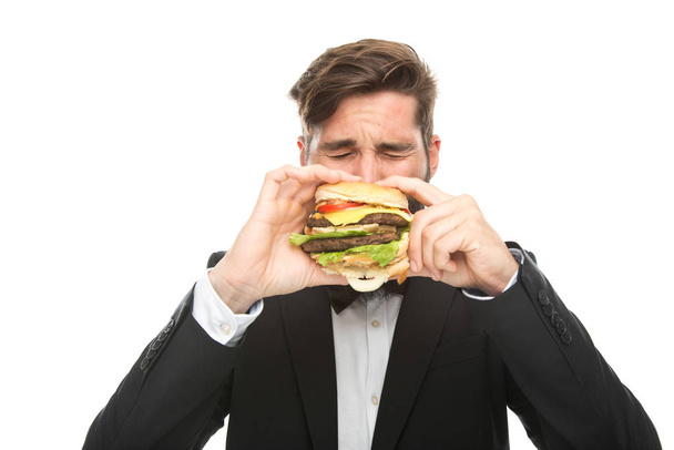 man with burger in hand - Foto, afbeelding