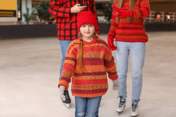 Little girl with parents on skating rink - Photo, Image