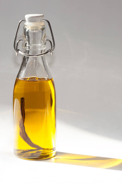 olive oil in a glass bottle on a white background - Foto, imagen