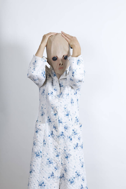 Alien difficult to wake in the morning.Rubbing one's eyes and drinking a big cup of coffee.dressing-up clothes and conceptual parody - Φωτογραφία, εικόνα