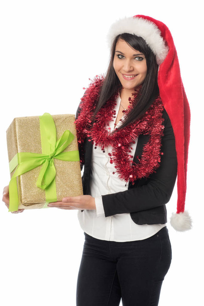 a young woman with santa claus hat holding a christmas present - 写真・画像