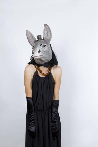 Woman wearing a donkey mask with an evening dress and evening gloves - Foto, Bild