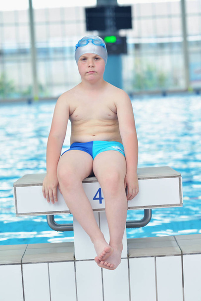 happy little child portrait on swimming school classes and recreation at indoor pool - 写真・画像