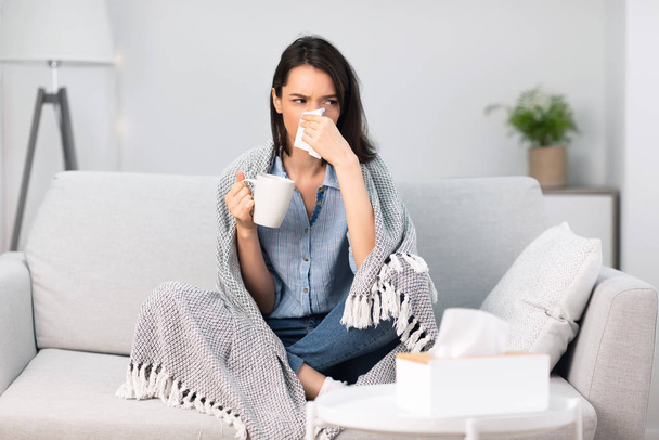 Sick woman wrapped in blanket drinking hot coffee - Photo, Image