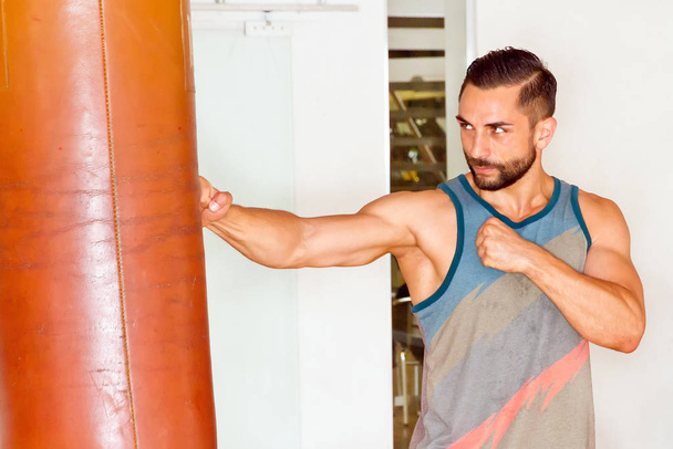 muscular man in sportswear doing push ups at gym - Фото, зображення