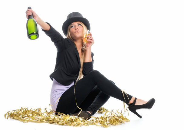 blonde woman with champagne bottle celebrating new year's eve - Photo, image