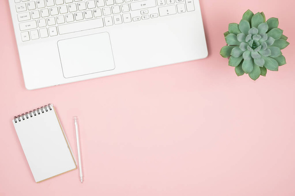 Flat lay home office desk. Women workspace with laptop, notebook, pen on pink background. Top view feminine background.  - Fotografie, Obrázek