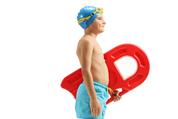 Boy in swimming trunks holding a swimming board - Photo, Image