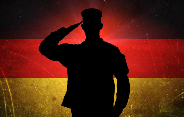 Proud german soldier on german flag background - Photo, Image
