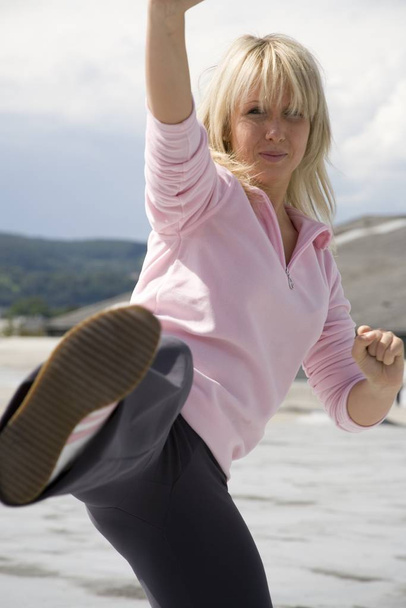 blonde woman trains taebo - Photo, Image
