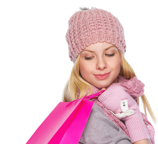 Girl in winter clothes with christmas shopping bag - 写真・画像