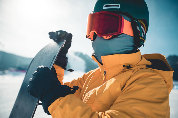 Female snowboarder with snowboard on winter mountain top - Foto, Imagem
