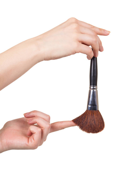 Female hands holding cosmetic brush for makeup close-up isolated - Foto, immagini