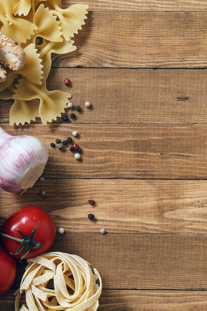 Overhead view of ingredients for an Italian pasta recipe on rustic wood background - Φωτογραφία, εικόνα