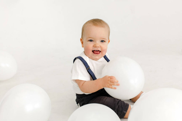 Joyful little kid with balloons in studio - Zdjęcie, obraz