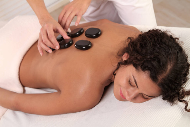 woman relaxing in a hot stone massage - Photo, image