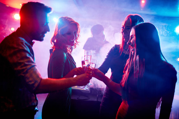 Group of friends toasting with champagne in night club - Valokuva, kuva