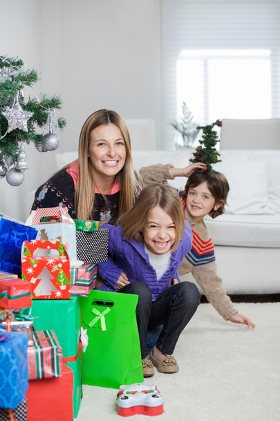 Mother With Children Sitting By Christmas Gifts - Фото, зображення