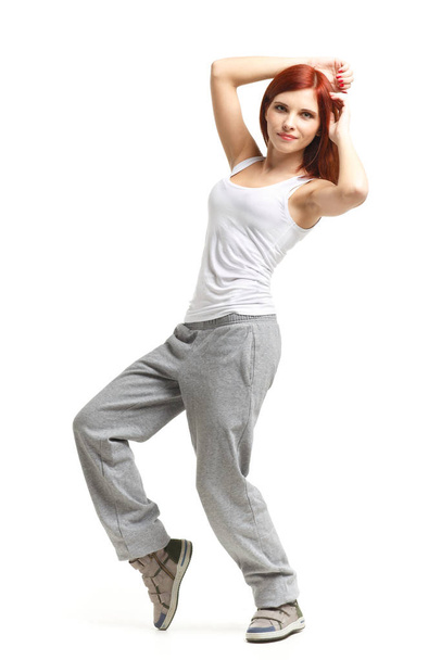 Young beautiful sports woman dancing on a white background. Modern dances. - Foto, imagen
