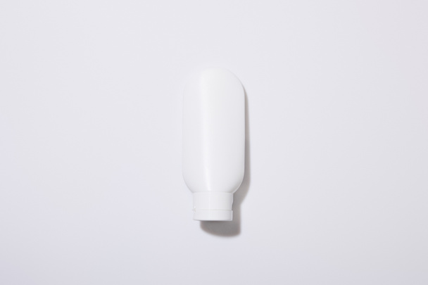 Top view of cosmetic tube on grey background - Fotoğraf, Görsel