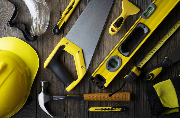 copy space with construction tools all around on wooden table background - 写真・画像