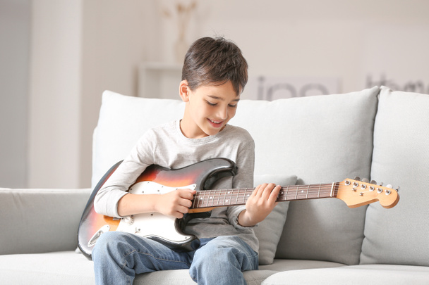 Little boy playing guitar at home - Φωτογραφία, εικόνα