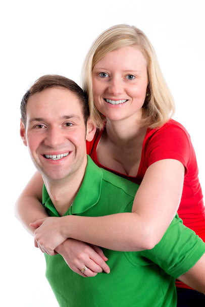 young couple in an embrace in front of white background - Foto, Bild